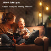 Woman and child reading a book on a couch with soft light creating a cozy ambiance.